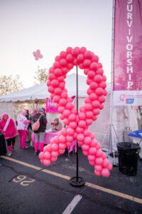 Pink balloons in the shape of a breast cancer ribbon.